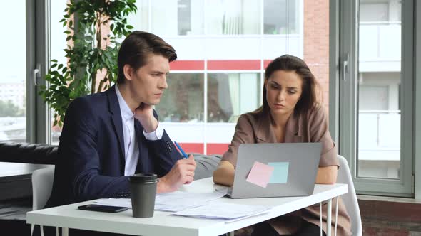 Endless loop of man and woman working with laptop while coffee cup steaming. alt