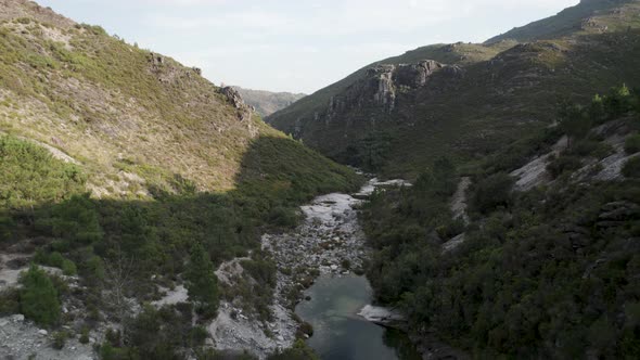 Aerial footage of a little river in the mountains valley of peneda geres national park
