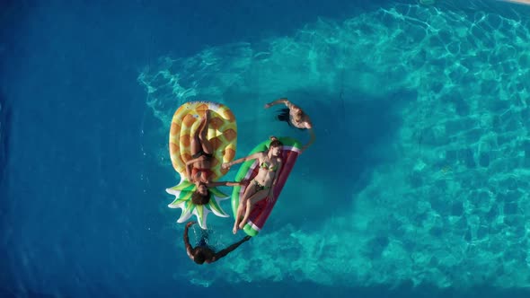 Drone View of Young People During Leisure in Pool alt