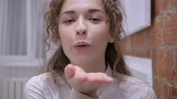 Flying Kiss by Woman in Bed alt