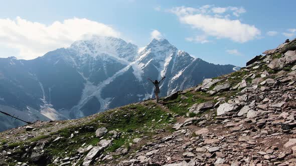 Sexy Female Traveler in a Dress Enjoys the Beauty of the Mountains Walks Along Mountain Trails and alt