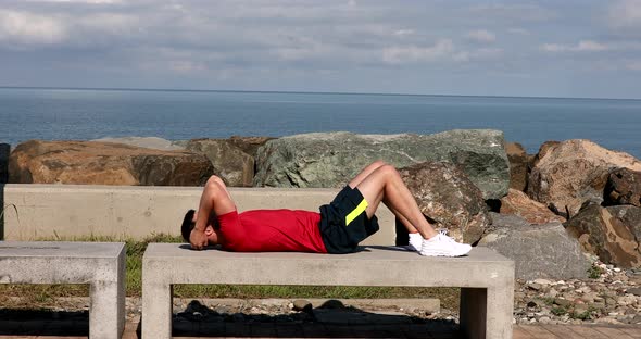 Athletic fit man wear sports clothes warm up training doing abdominal abs exercises. alt