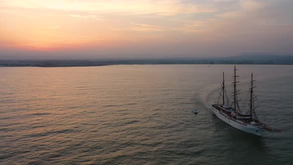 A Bird's Eye View of Ortigia Island at Sunset. Sailing Ship Out of the Bay. Sicily