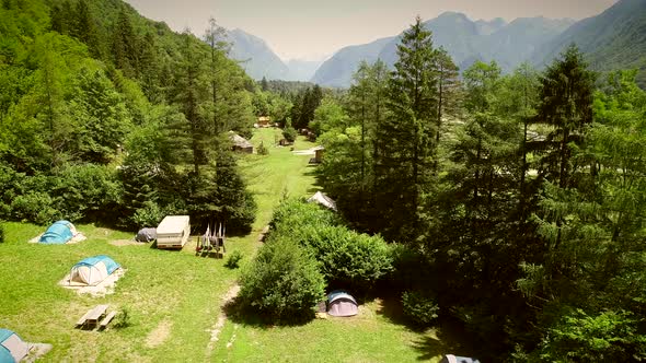 Aerial view of a summer camp with cabins and recreational area in the forest. alt