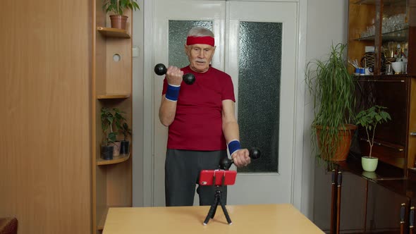 Mature Couple Man Fitness Trainer Coach Recording Video Online Workout Blog Course with Smartphone alt