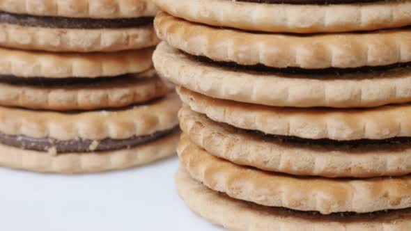 Slow tilt chocolate cream  filled sandwich cookies close-up  4K 2160p 30fps UltraHD footage - Fresh  alt