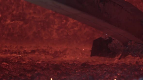 Slow Motion of Loader Mixing Red-hot Aluminium in Bowl in Aluminium Plant. Aluminium Foundry Furnace alt