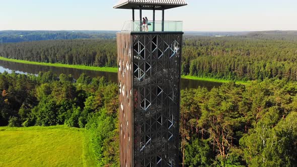 Couple Stands On Famous Observation Tower Landmark In Lithuania alt