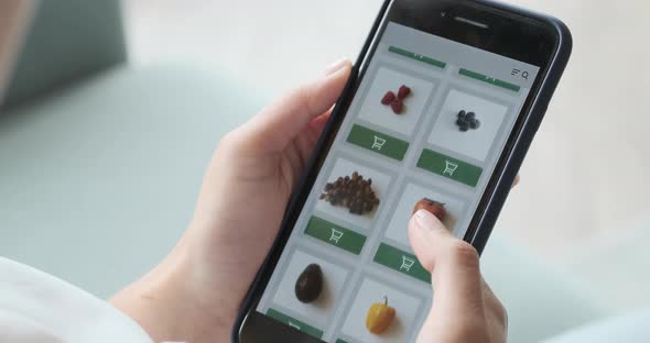 Ordering Food Vegetables and Fruits Online Using Smartphone App Close Up alt
