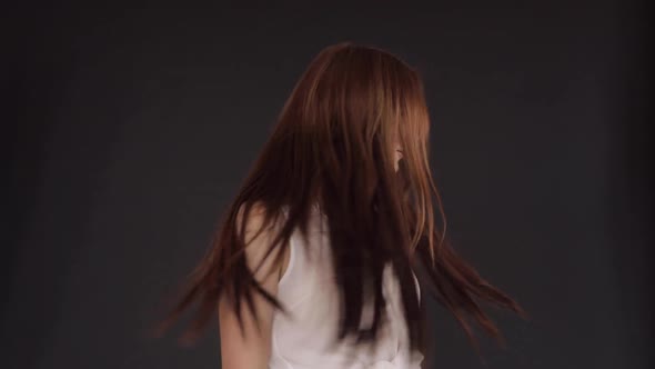 Sexy Woman Twirling and Dancing on Black Isolated Background alt