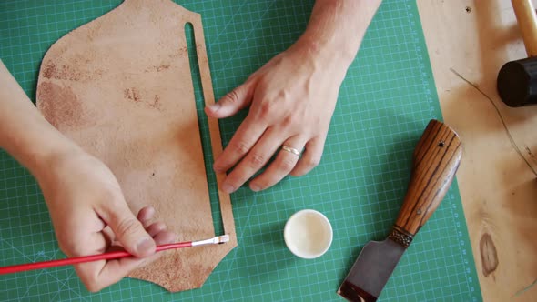 Tanner Applying Glue on Leather Detail alt