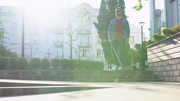 Young Blind Man with Using Safety Stick for Walking Alone Outdoors alt