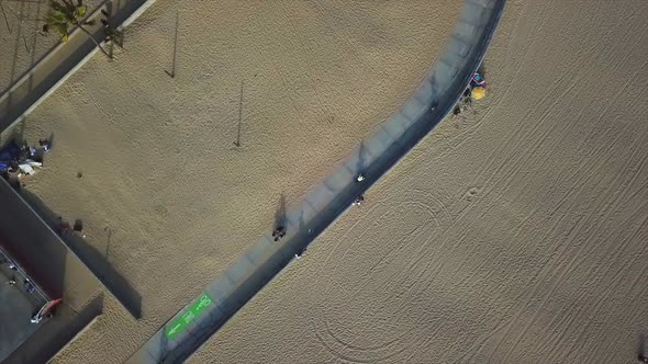 Venice beach California Drone shot panning out with a rotation over bike trail. alt