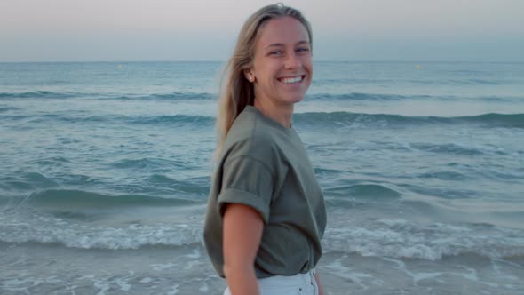 Real Authentic Millennial Woman Walk on Beach  alt