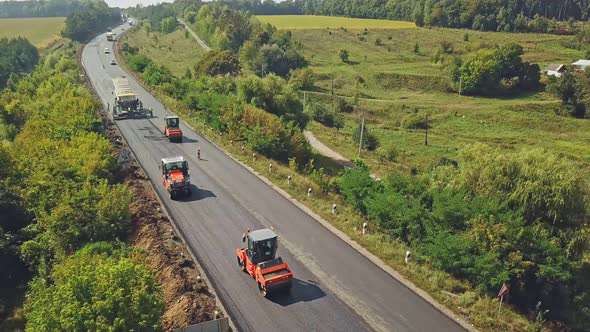 Road Rollers Working on the New Road Construction Site alt
