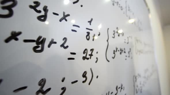 Female Student is Solved Math Equation on Whiteboard in the Cabinet