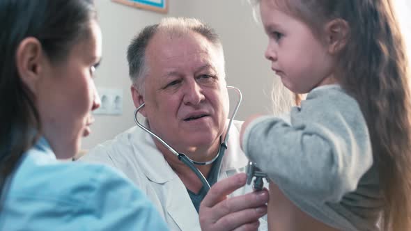 Doctor examining kid with stethoscope