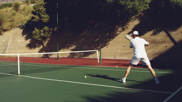 Man playing tennis on a sunny day alt