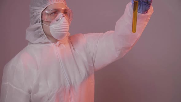 Protected Scientist Pouring Liquid in a Laboratory. Research and Science Concept alt