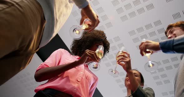 Businesspeople toasting glasses of champagne alt