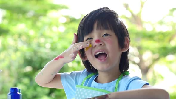 Close Up Of Asian Child Painting alt