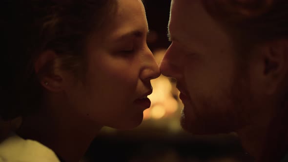 Authentic Married Couple Kissing in Cozy House Fireplace alt