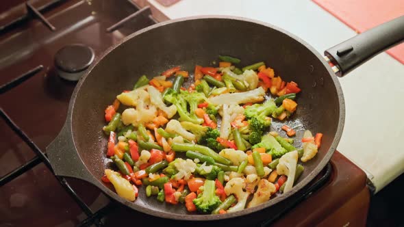 Slow Motion Closeup of Frying Vegetables in Pan with Steam and Without Lid alt