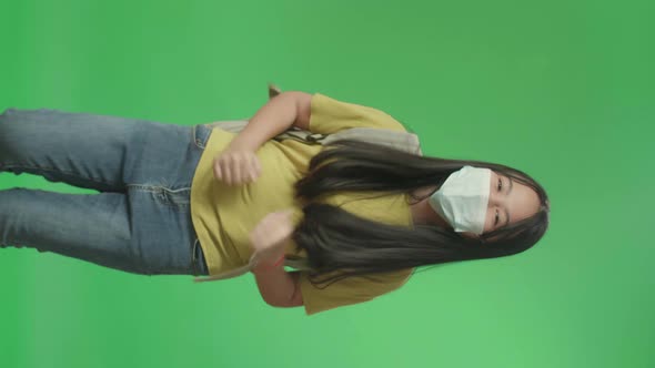 Asian Girl Student Wearing Mask And Running To School On Green Screen Chroma Key alt