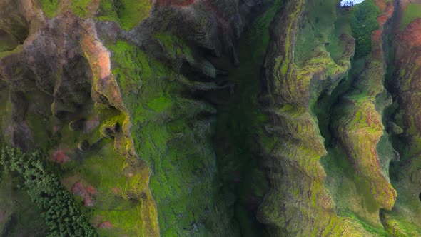 Grassy Rocks of Mountainous Coastal Terrain of Hawaii Illuminated By Sunset Light. Aerial Shot alt