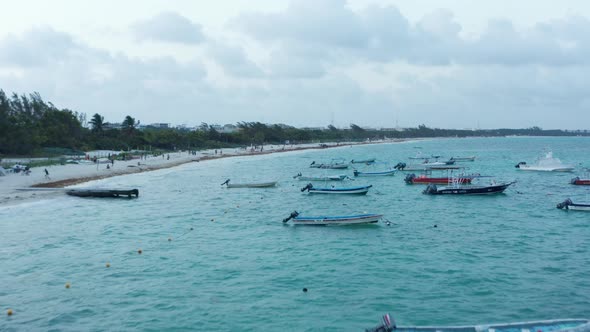 Drone Flying Above Moored Boats at the Seashore at Playa Del Carmen Mexico alt
