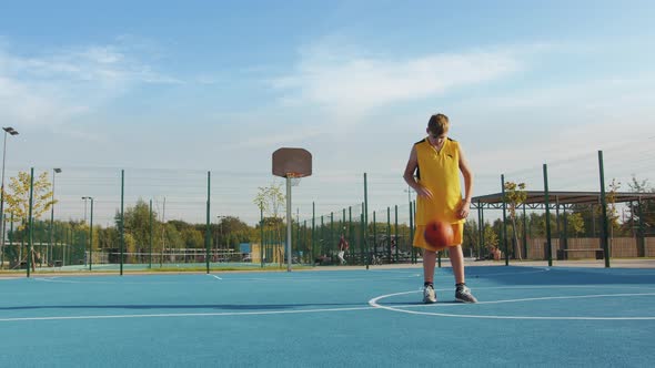 Young boy with a ball on the court alt