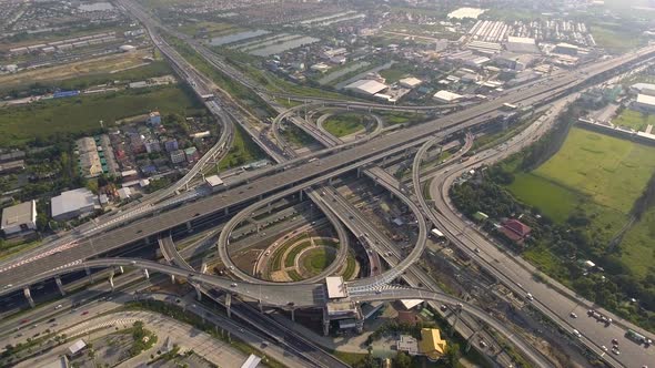 Aerial View of Highway Road Interchange with Busy Urban Traffic Speeding on Road alt