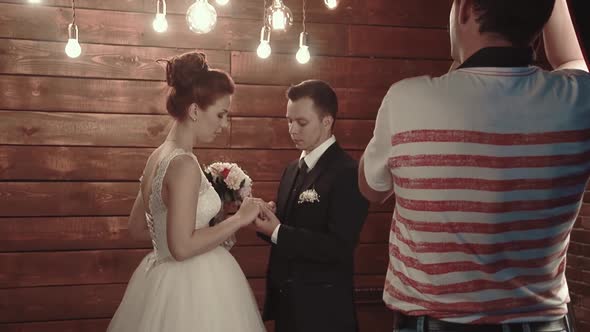 Photographer Photographs Newlyweds During the Wedding Ceremony alt