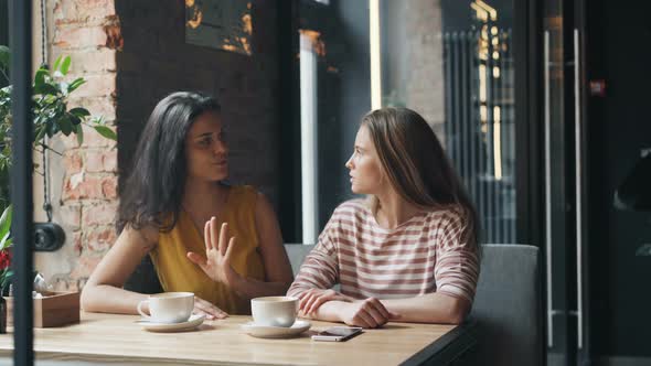 Joyful Friends Ordering Food in Cafe Talking To Friendly Female Waitress Smiling alt