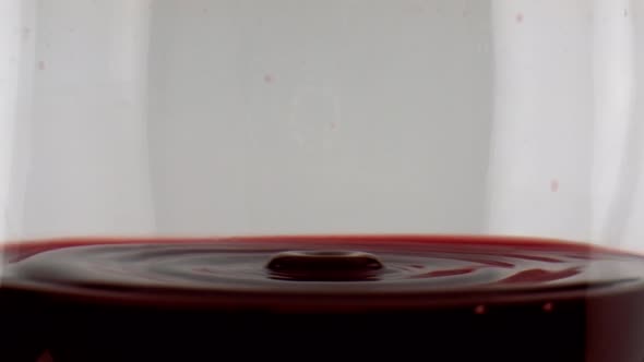 Red Wine Dripping Glass Closeup alt