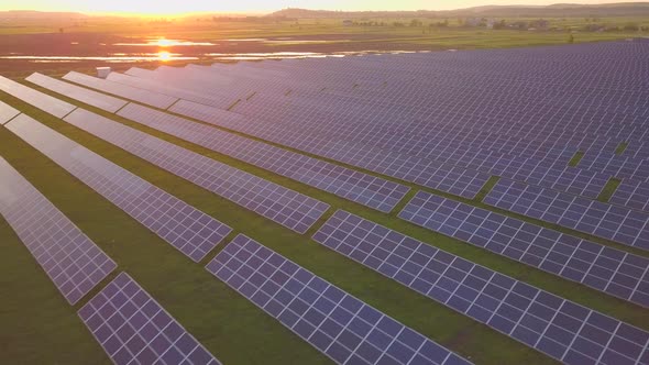 Aerial view of green field with solar energy panels for renewable electricity production. alt