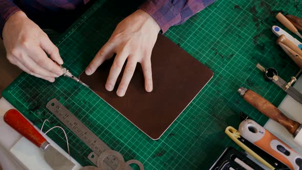 Master Cuts the Edge of the Skin. Full Cycle of Production Traveled a Case of Leather. Handmade