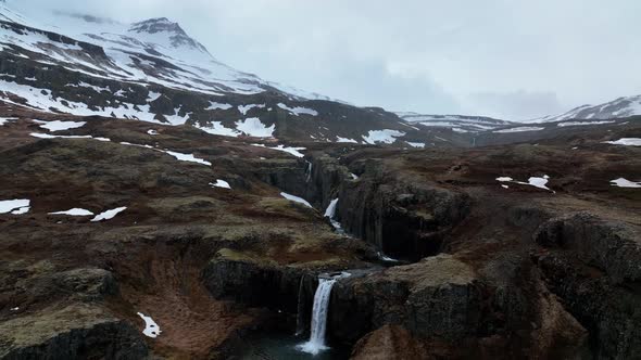 Scenic Klifbrekkufossar Waterfall In East Iceland - aerial pullback alt
