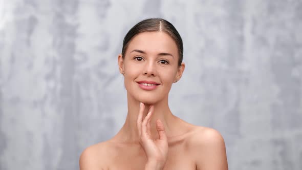 Portrait of Naked Woman with Perfect Skin Stroking Chin alt