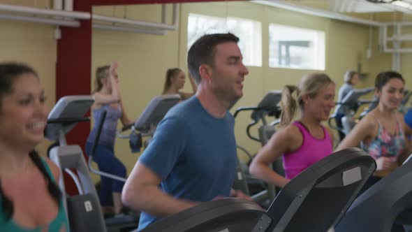 People at gym running on treadmills