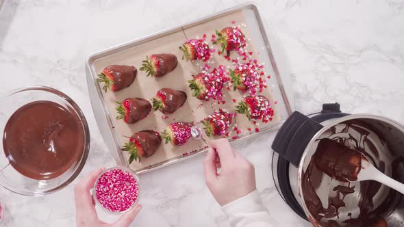 Flat lay. Step by step. Garnishing chocolate dipped strawberries with sprinkles. alt