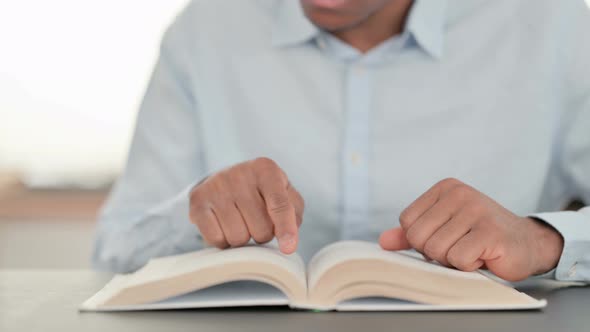 African Man Hands Turning Pages of Book Close Up alt