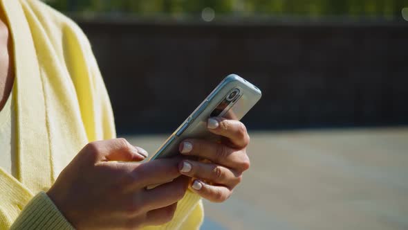 Closeup Footage of Female Hands with Smartphone Outdoor alt