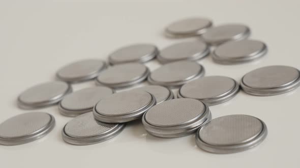 Panning on same type watch button batteries close-up 4K video alt