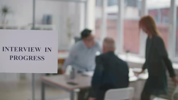 Interview in Progress Sign on Glass alt