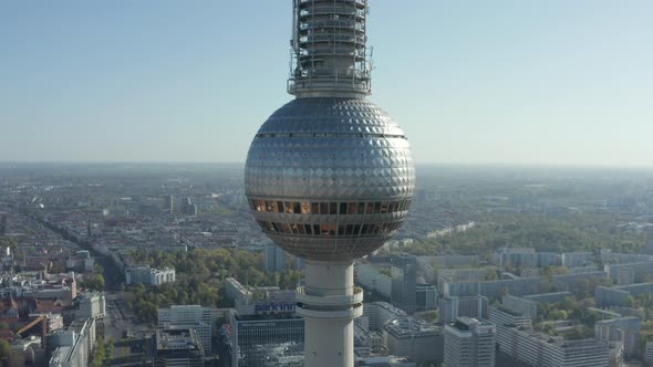 AERIAL: Super Close Up View of the Alexanderplatz TV Tower in Berlin, Germany on Hot Summer Day  alt