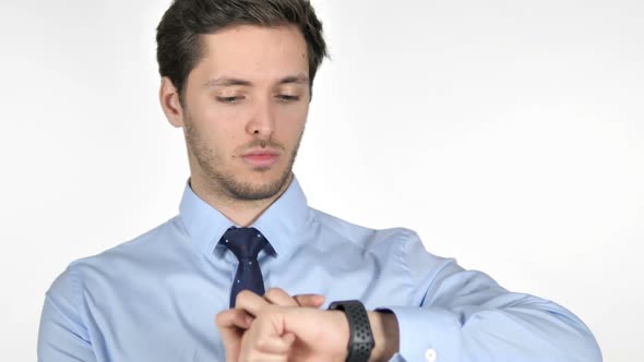 Young Businessman Using Smartwatch on White Background alt