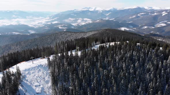 Aerial Ski Slopes with Skiers and Ski Lifts on Ski Resort. Snowy Mountain Forest alt