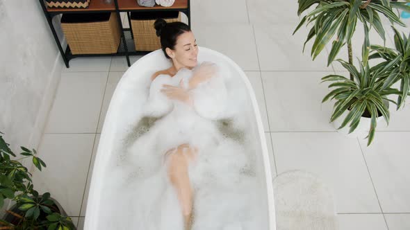 Slow Motion of Happy Young Woman Bathing in Modern Bathtub Smiling Relaxing Alone alt