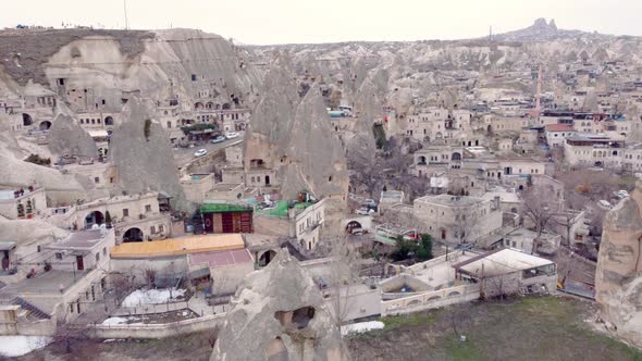 Goreme town with mosque and residences in rock formations, Cappadocia region, Turkey alt